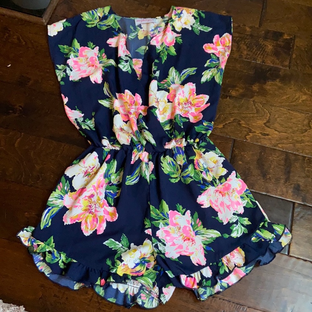 Floral navy romper with ruffle around leg